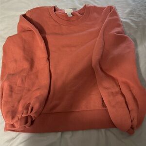 orangey colored crewneck